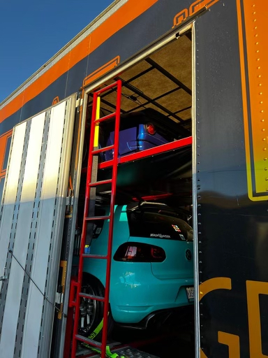 Cars transported in an enclosed trailer